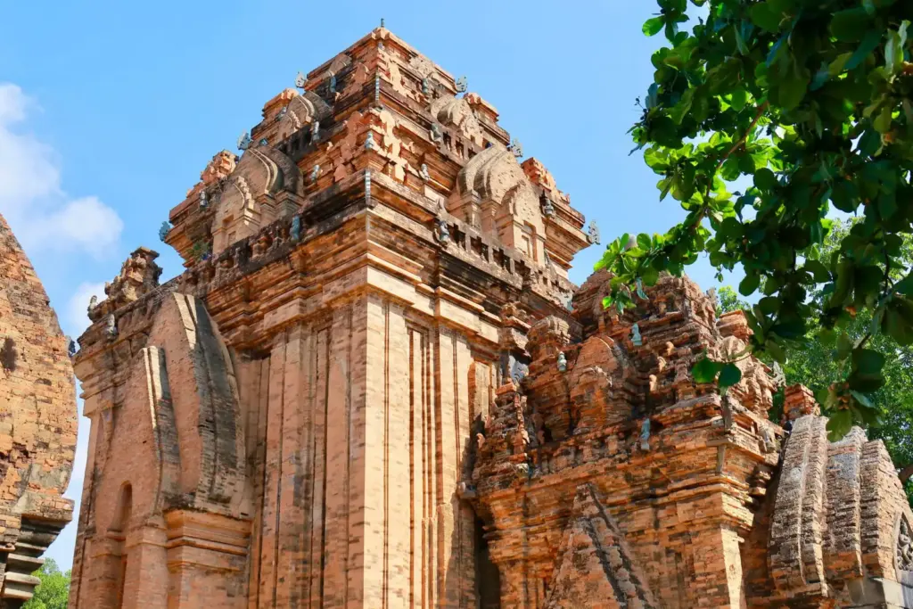 Intricate ancient Cham architecture of the historic Po Nagar Towers under a clear blue sky in Nha Trang, Vietnam.