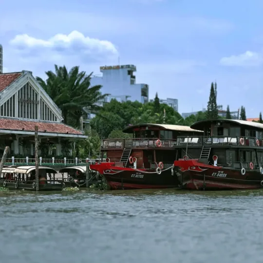 Traditional wooden boats moored along the riverfront near Cai Rang, Can Tho