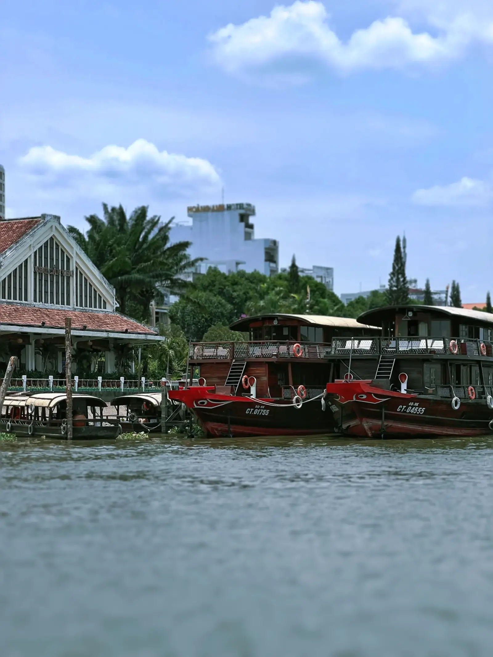 Traditional wooden boats moored along the riverfront near Cai Rang, Can Tho
