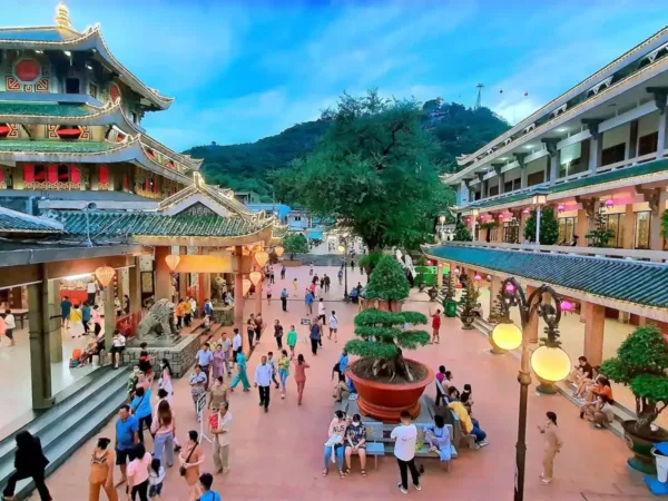 Visitors gathering in the courtyard of a temple complex in Chau Doc, An Giang