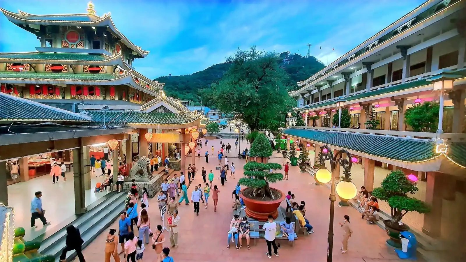 Visitors gathering in the courtyard of a temple complex in Chau Doc, An Giang