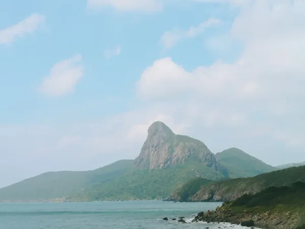 A dramatic rocky peak rising above the coastline of Con Dao island