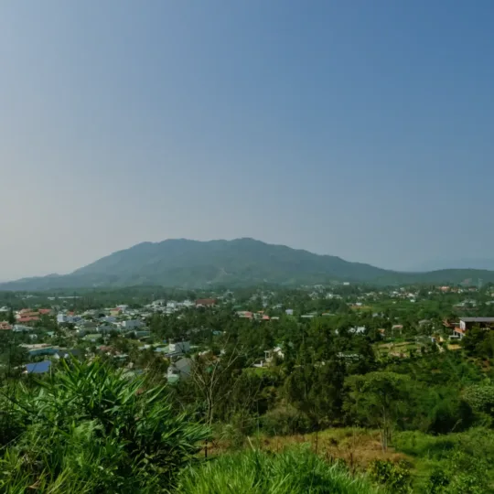 Countryside with mountains, a village and blue sky in the Central Highlands
