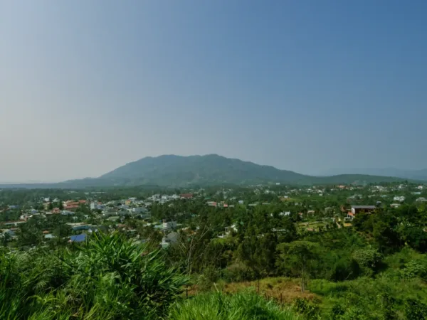 Countryside with mountains, a village and blue sky in the Central Highlands