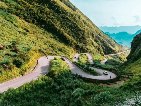 Cars and motorbikes navigating the hairpin switchbacks of Ma Pi Leng Pass in Ha Giang