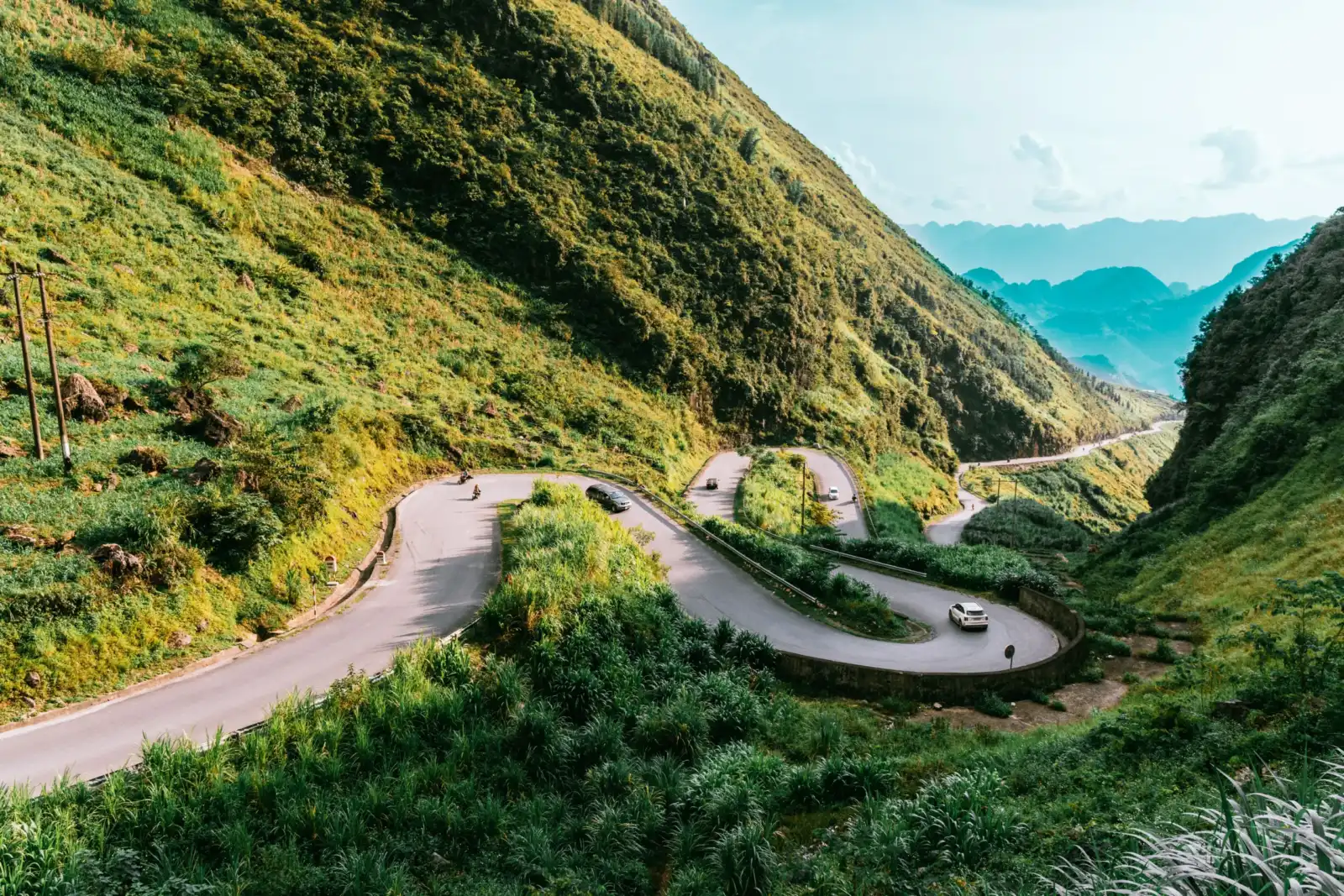 Cars and motorbikes navigating the hairpin switchbacks of Ma Pi Leng Pass in Ha Giang