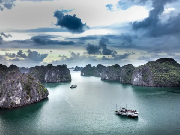Limestone karsts and cruise boats on the waters of Ha Long Bay