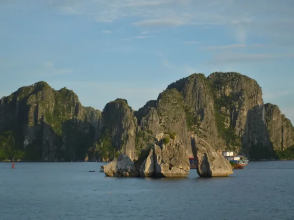 Limestone karsts in Ha Long Bay under a clear blue sky