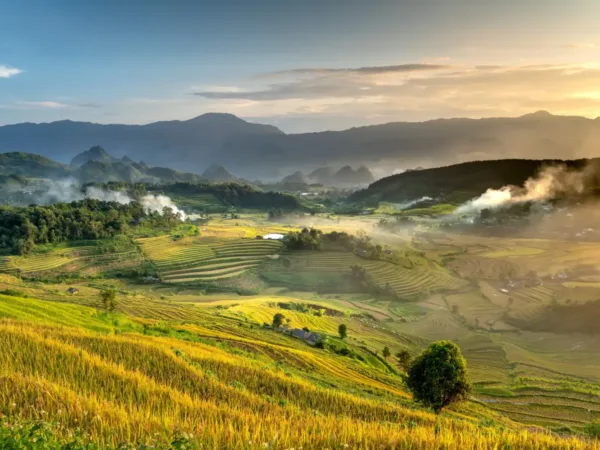 Golden rice terraces and misty villages in Mai Chau Valley at sunset, Hoa Binh