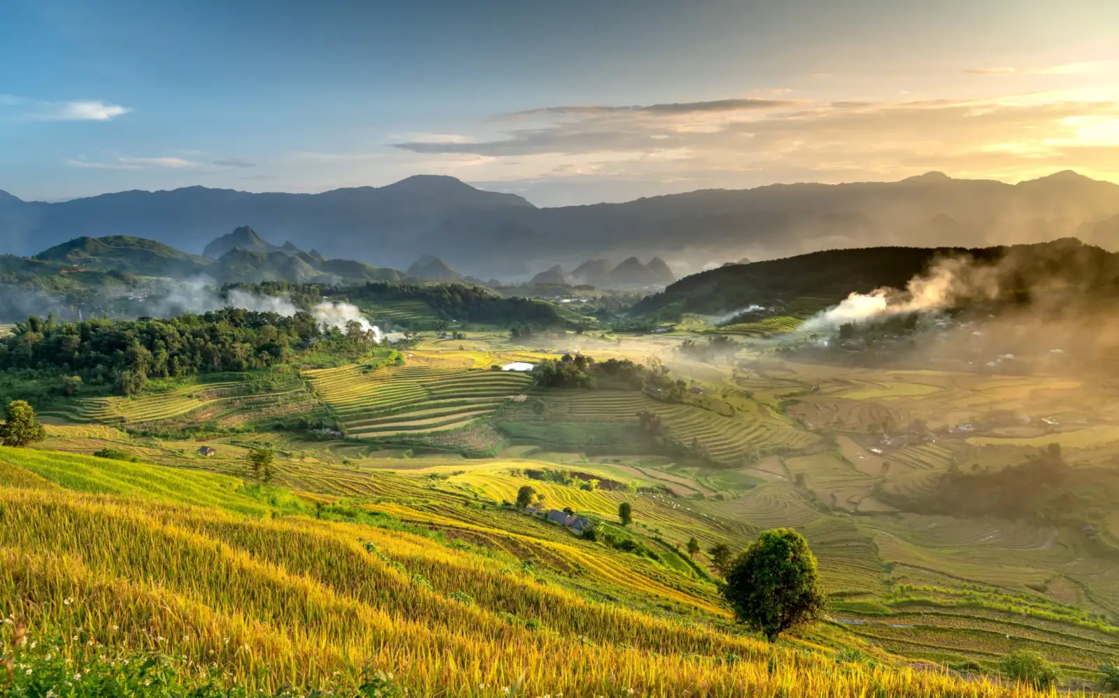 Golden rice terraces and misty villages in Mai Chau Valley at sunset, Hoa Binh