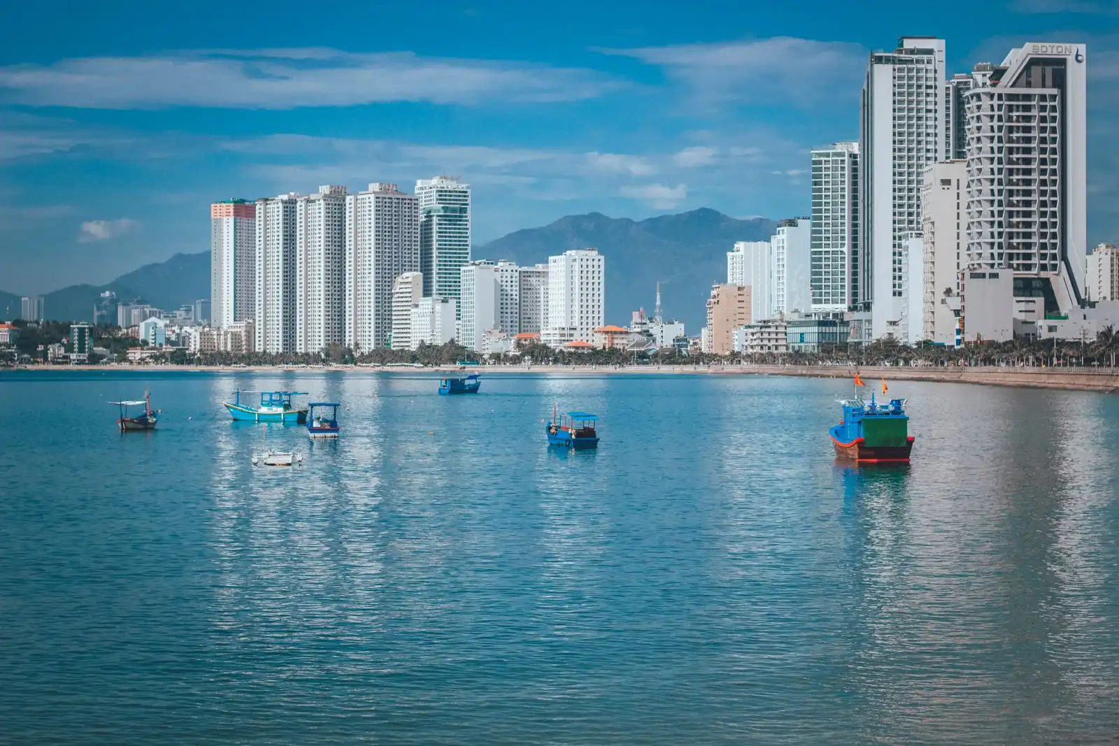 Nha Trang skyline with boats on calm blue water