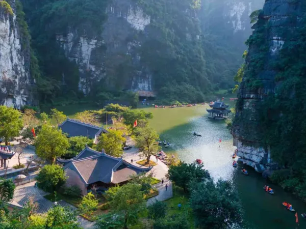 Ninh Binh weather guide showing boat tours along green rice paddies and limestone karsts
