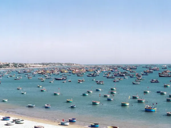 Hundreds of colorful fishing boats anchored in the bay off Phan Thiet