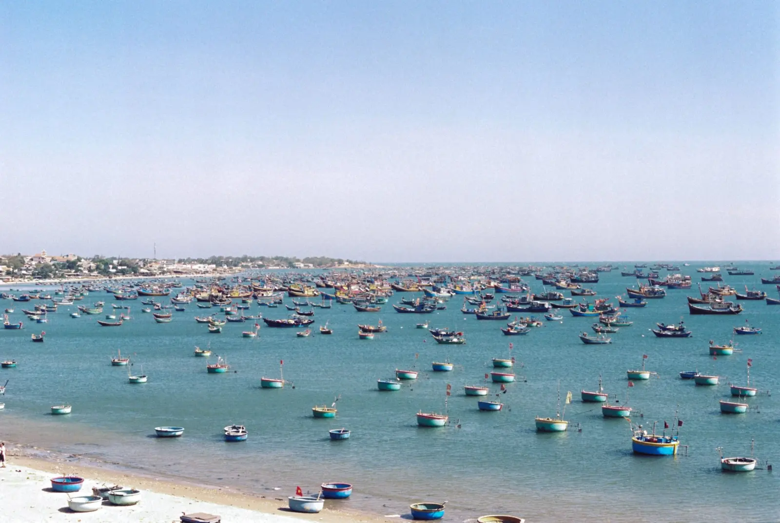 Hundreds of colorful fishing boats anchored in the bay off Phan Thiet