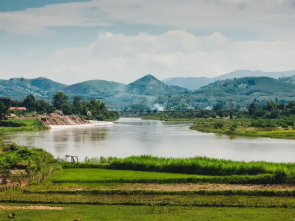 A calm river winding through green hills and rice fields near Pleiku, Gia Lai