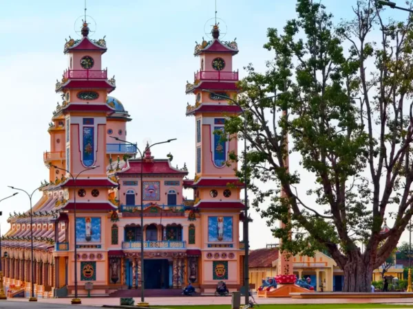 The colorful twin-towered facade of the Cao Dai Holy See temple in Tay Ninh