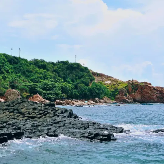 Hexagonal basalt rock formations along the coast at Ghenh Da Dia, Phu Yen