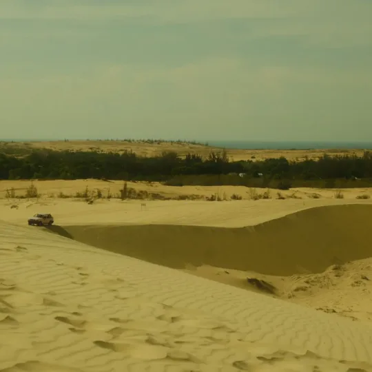 Vast sand dunes under a bright sky in Mui Ne