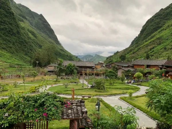 Village between green mountains under a cloudy sky in northern Vietnam