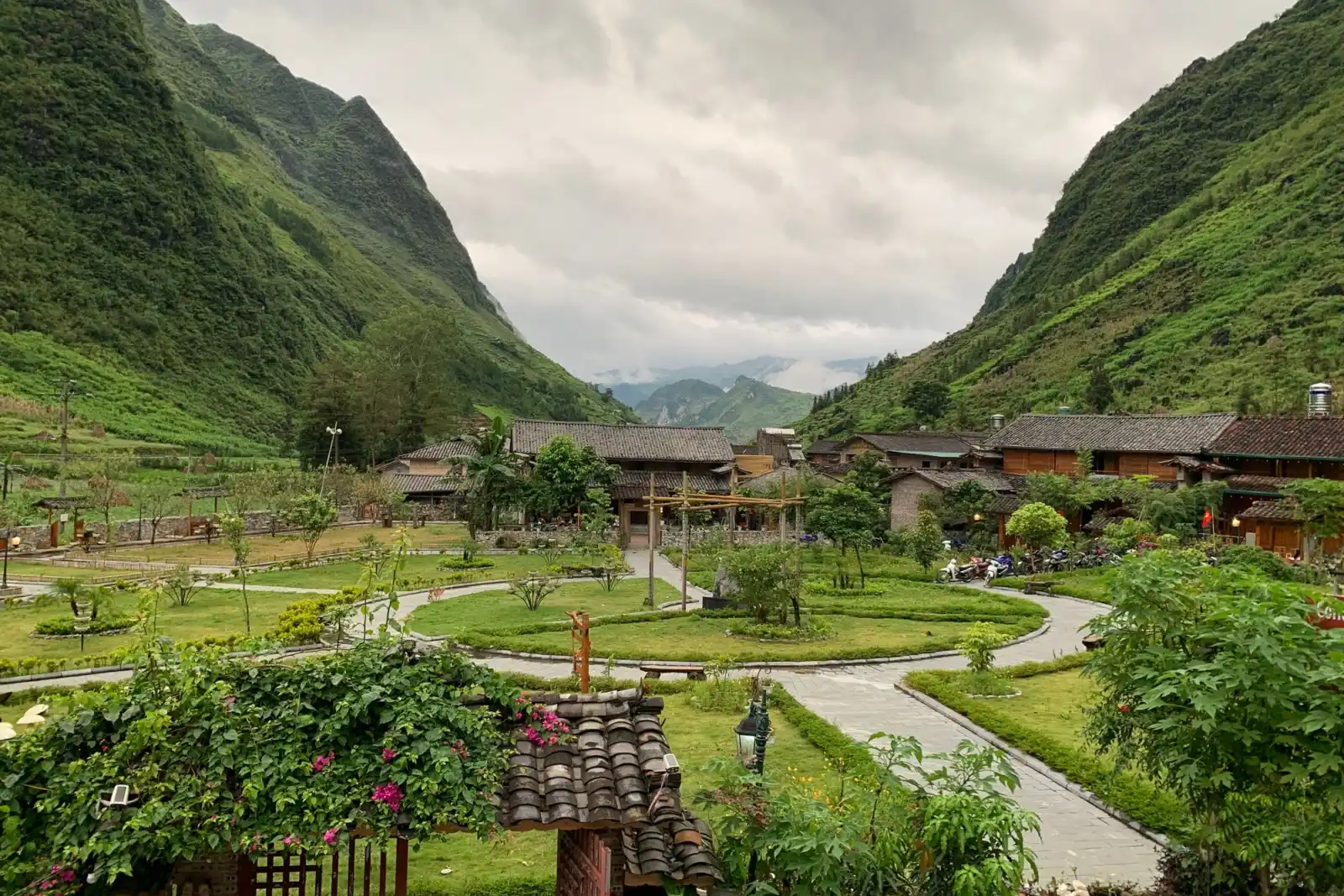 Village between green mountains under a cloudy sky in northern Vietnam
